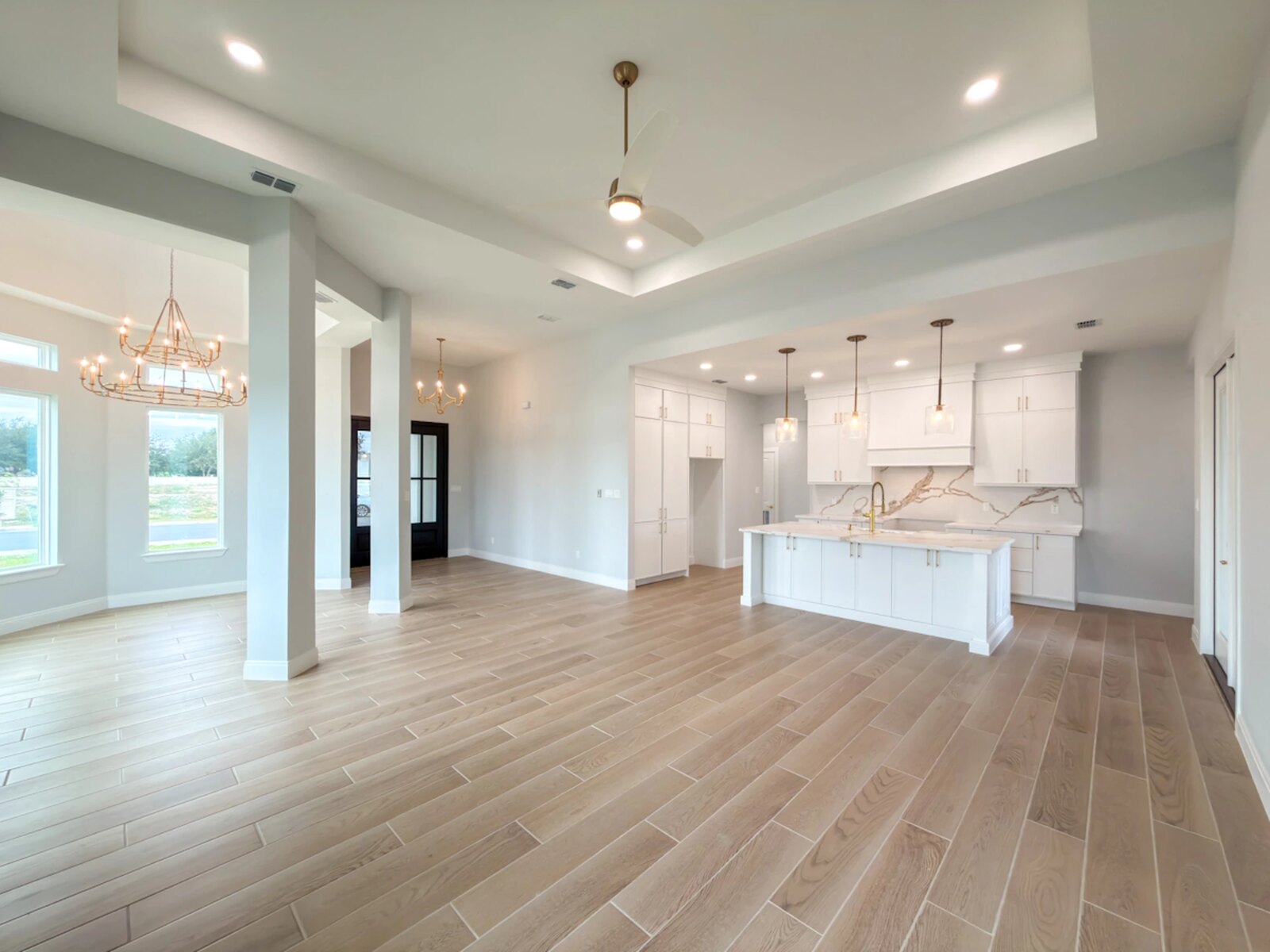 Open kitchen, dining, and great-room of a finished M Construction custom home